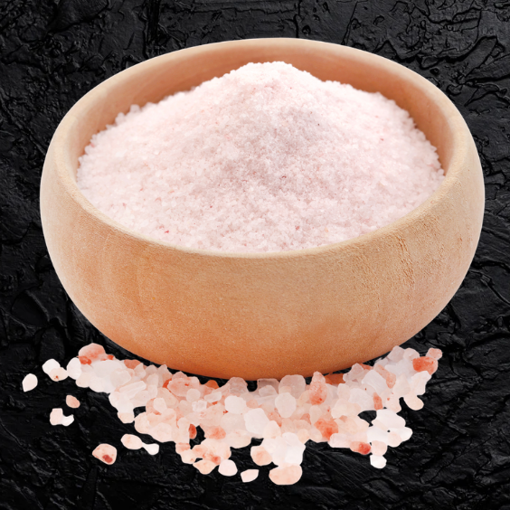 Wooden bowl filled with pink Himalayan salt on a black textured background